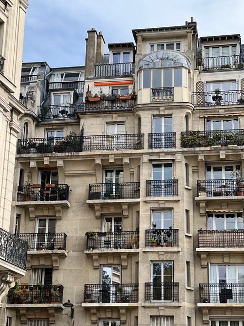 Free A detailed view of a classic residential apartment building with unique architectural elements. Stock Photo