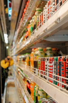 A vibrant array of assorted drinks displayed on shelves in a grocery store setting. Perfect for retail imagery.