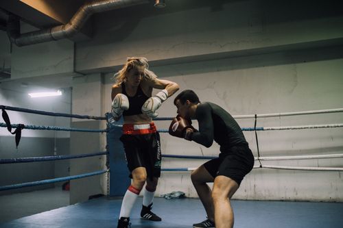 Free Two boxers sparring intensely in an indoor gym boxing ring, showcasing skill and fitness. Stock Photo