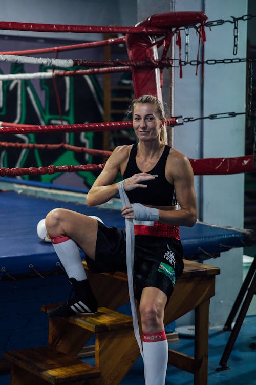 A Woman Sitting Beside the Boxing Ring