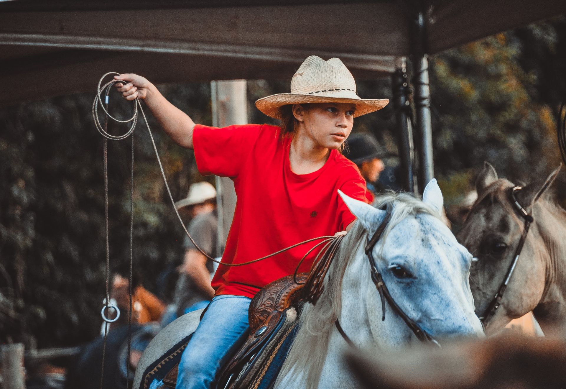 A Kid in Red Shirt Riding a White Horse