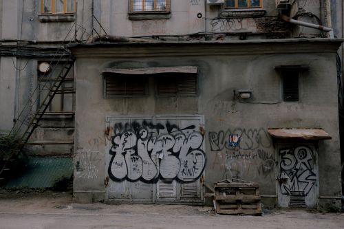 Free Graffiti-covered abandoned building depicting urban decay and neglect. Stock Photo
