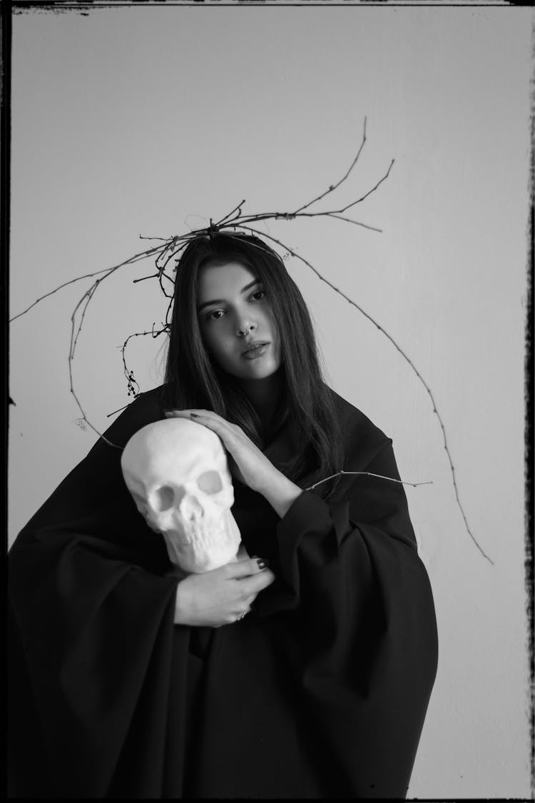 Girl In Halloween Costume Holding Skull