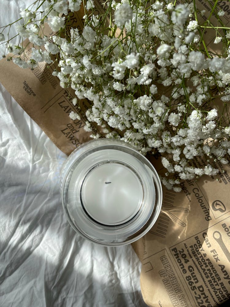 Directly Above View Of Candle And White Flowers