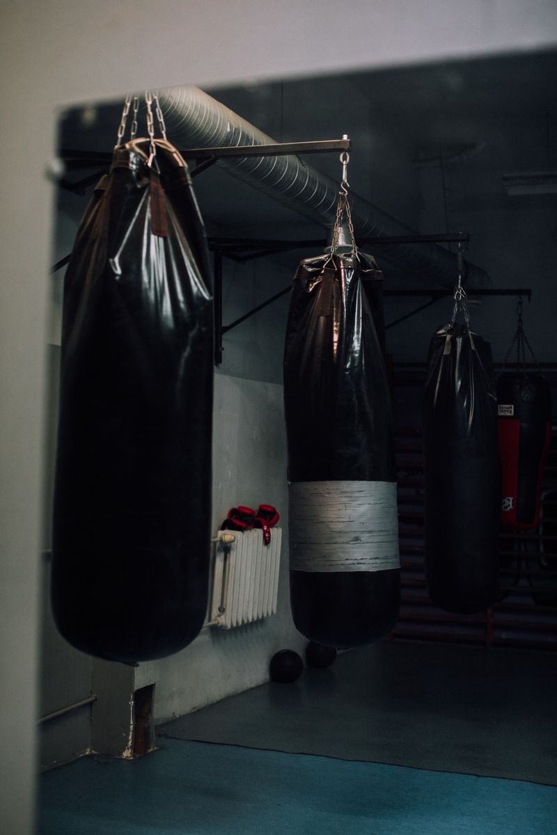 Boxing coach working mitts with a member