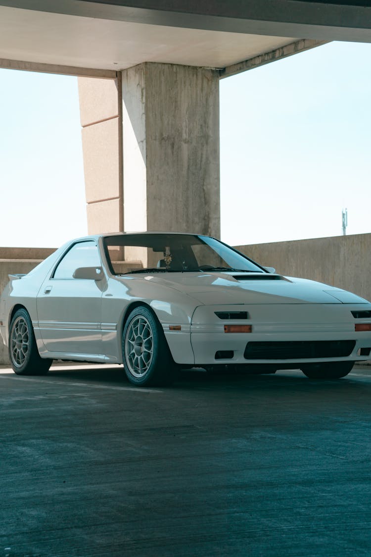 White Car Parked In Empty Parking Lot