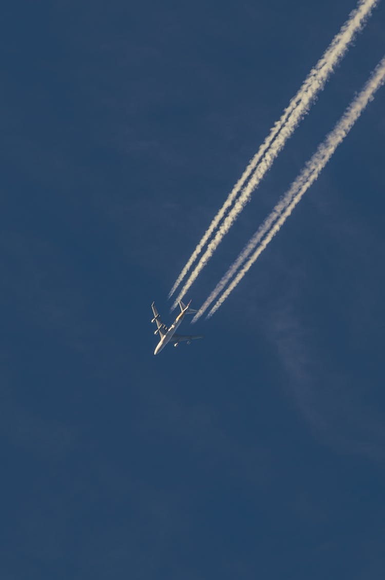 Airplane Leaving Vapor Trail In Sky 