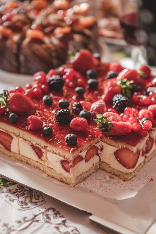 Red and White Cake With Strawberry on Top