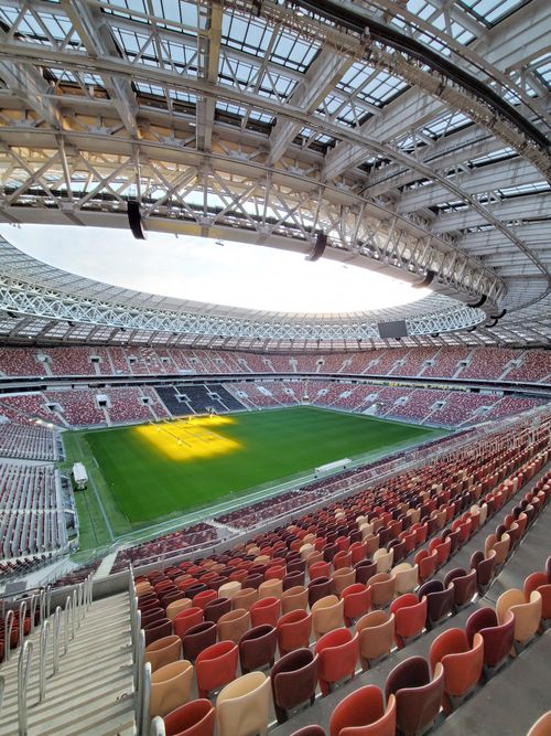 Free Explore the vastness of this modern football stadium with panoramic seating and open roof. Stock Photo