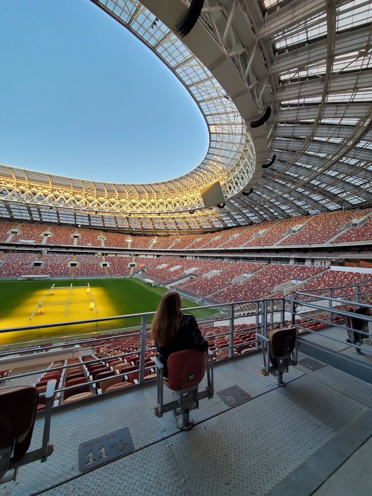 A Person Sitting On A Stadium Seat