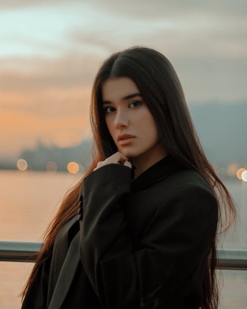 A Portrait of Female Looking At Camera During Sunset 