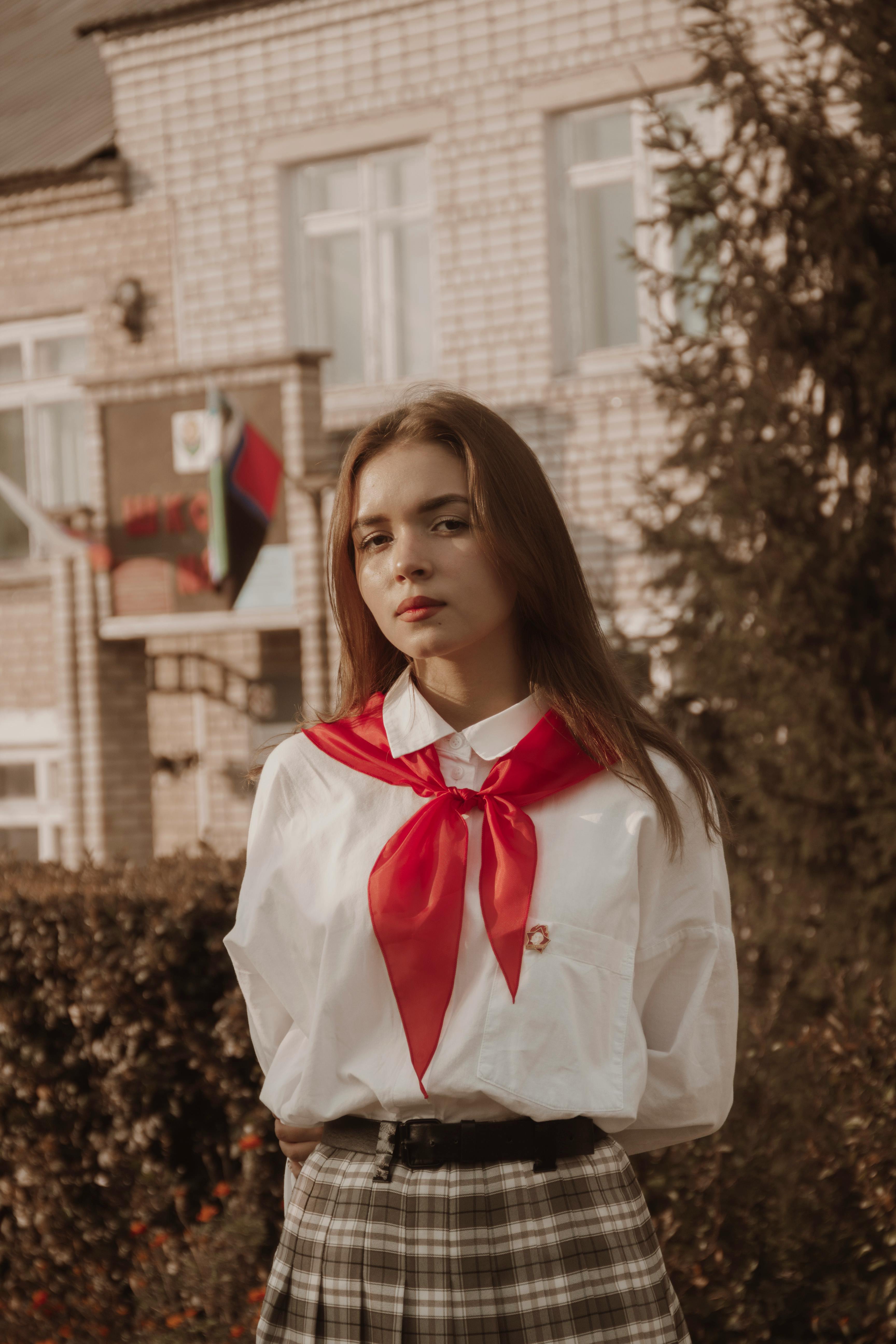 portrait of brown hair girl with her hands behind back