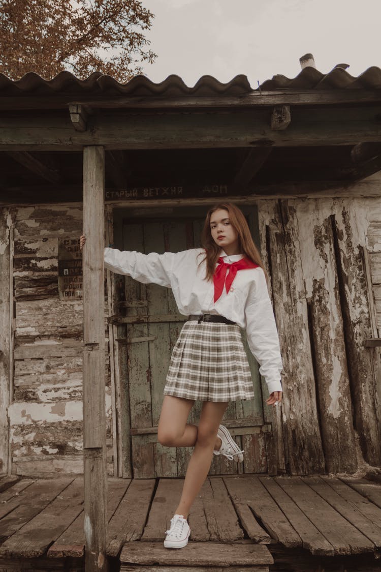 Portrait Of Brown Hair Girl Standing On One Leg