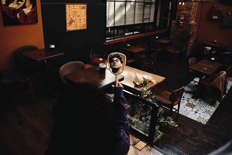 Unrecognized Woman Holding Mirror With Reflecting Mans Face