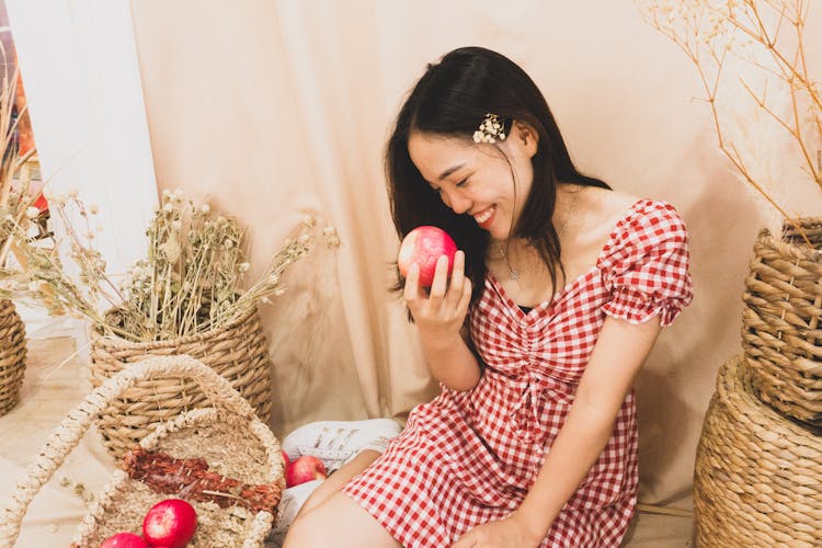 Photograph Of A Girl Holding An Apple