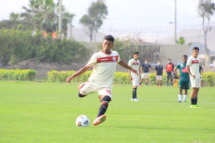 Photo Of A Man Kicking A Soccer Ball