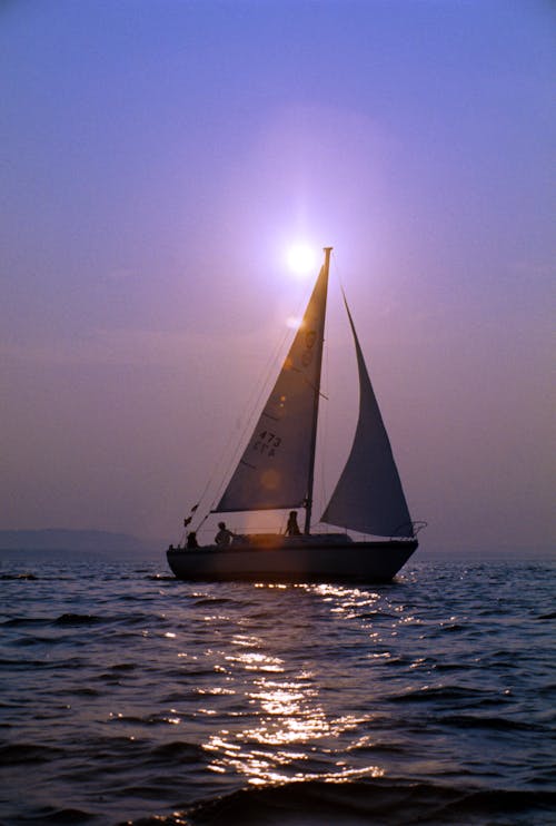 Photograph of a Sailboat on the Ocean on a Sunny Day