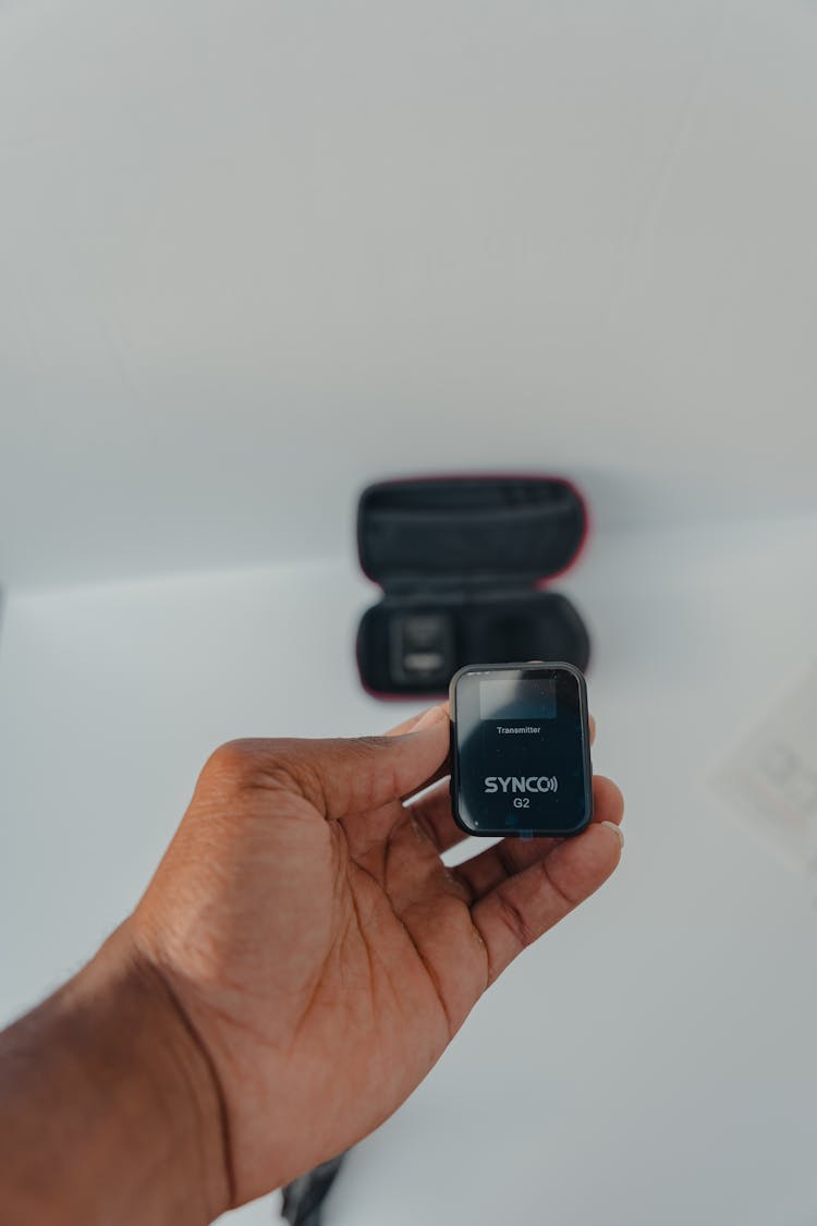 Photograph Of A Person's Hand Holding A Wireless Microphone