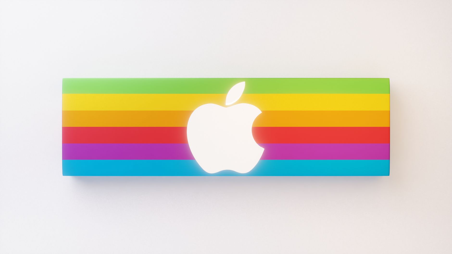 Vibrant rainbow-striped apple logo on a minimalist white backdrop.