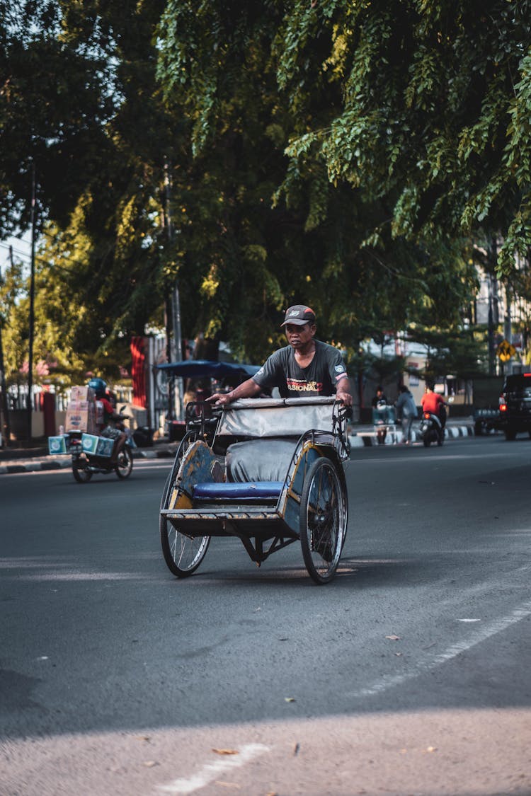 Man Driving Empty Rickshaw