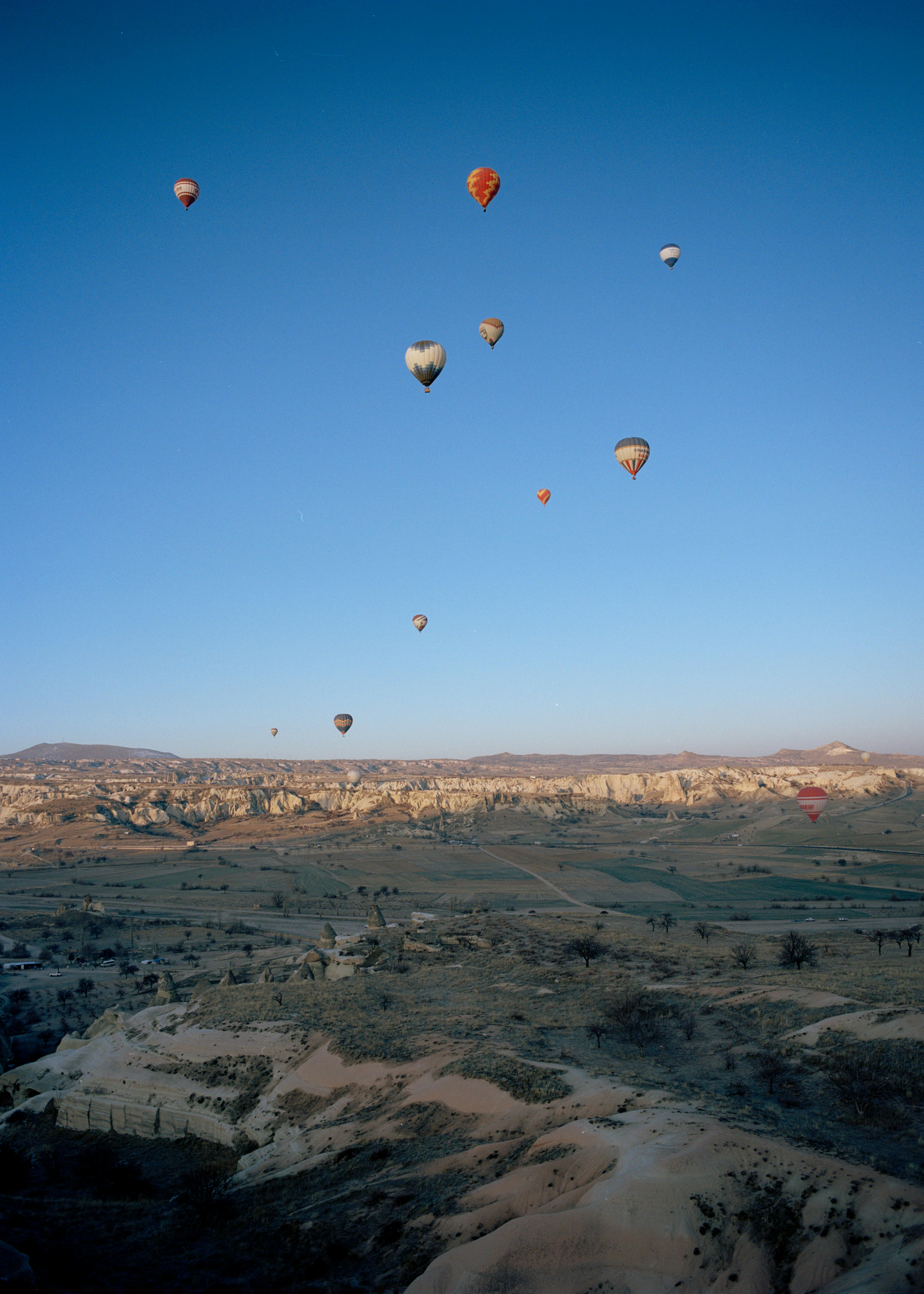 hot air baloons flying over desert