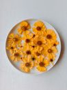 Composition of Yellow Flowers on White Plate