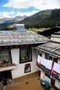 Brown and White Roof Near Green Mountains