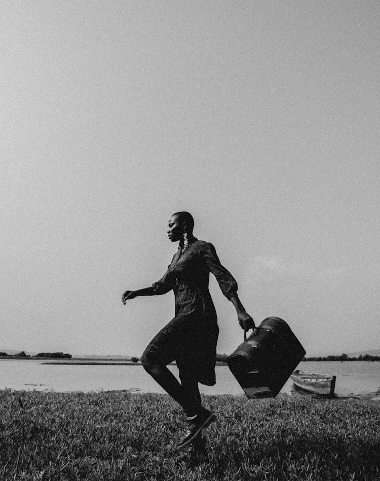 Black And White Picture Of Man Carrying Big Bag