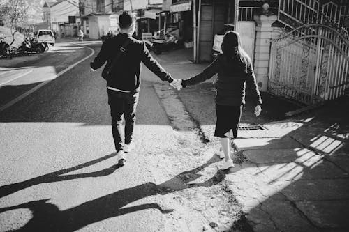 Man and Woman Walking in Town