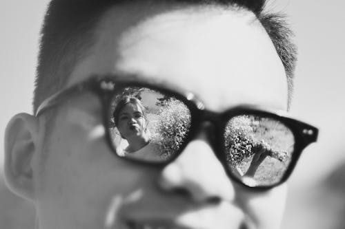 Grayscale Photo of a Man Wearing Sunglasses