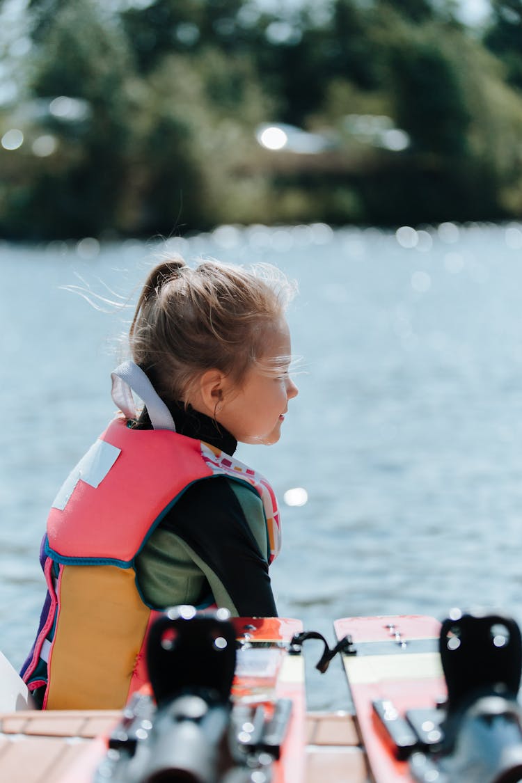 Side View Of Young Girl Preparing To Wake Boarding