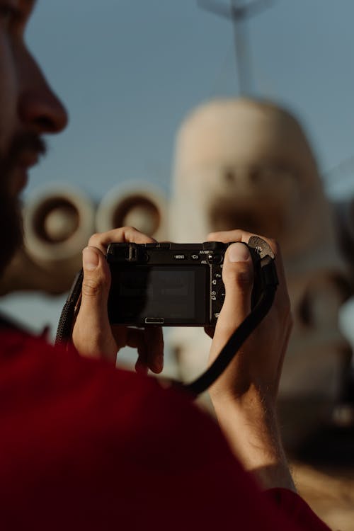 Photograph of a Man Holding a Black Camera