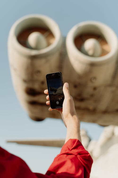 Free Photo of a Person's Hand Holding a Black Cell Phone Stock Photo