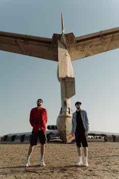 Two men posing in front of Lun-Class Ekranoplan at Park Patriot, Russia.