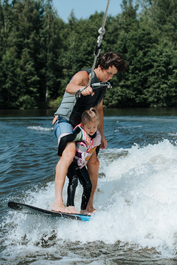 Father And Daughter Wake Surfing