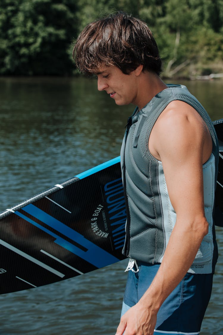 Man Carrying Wakesurf Board