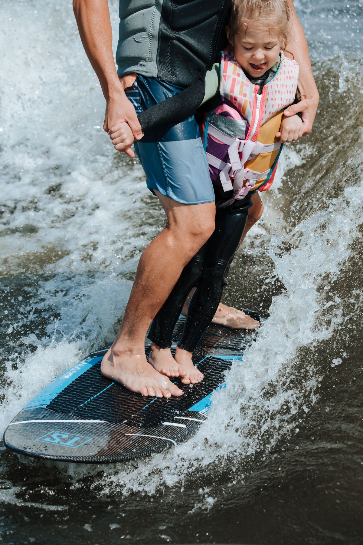 Rider's view standing on a board behind a boat on a lake