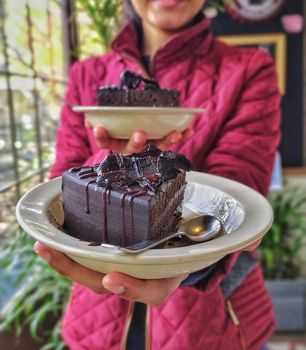 Close-up of a rich chocolate cake slice served on a plate, perfect for dessert lovers.