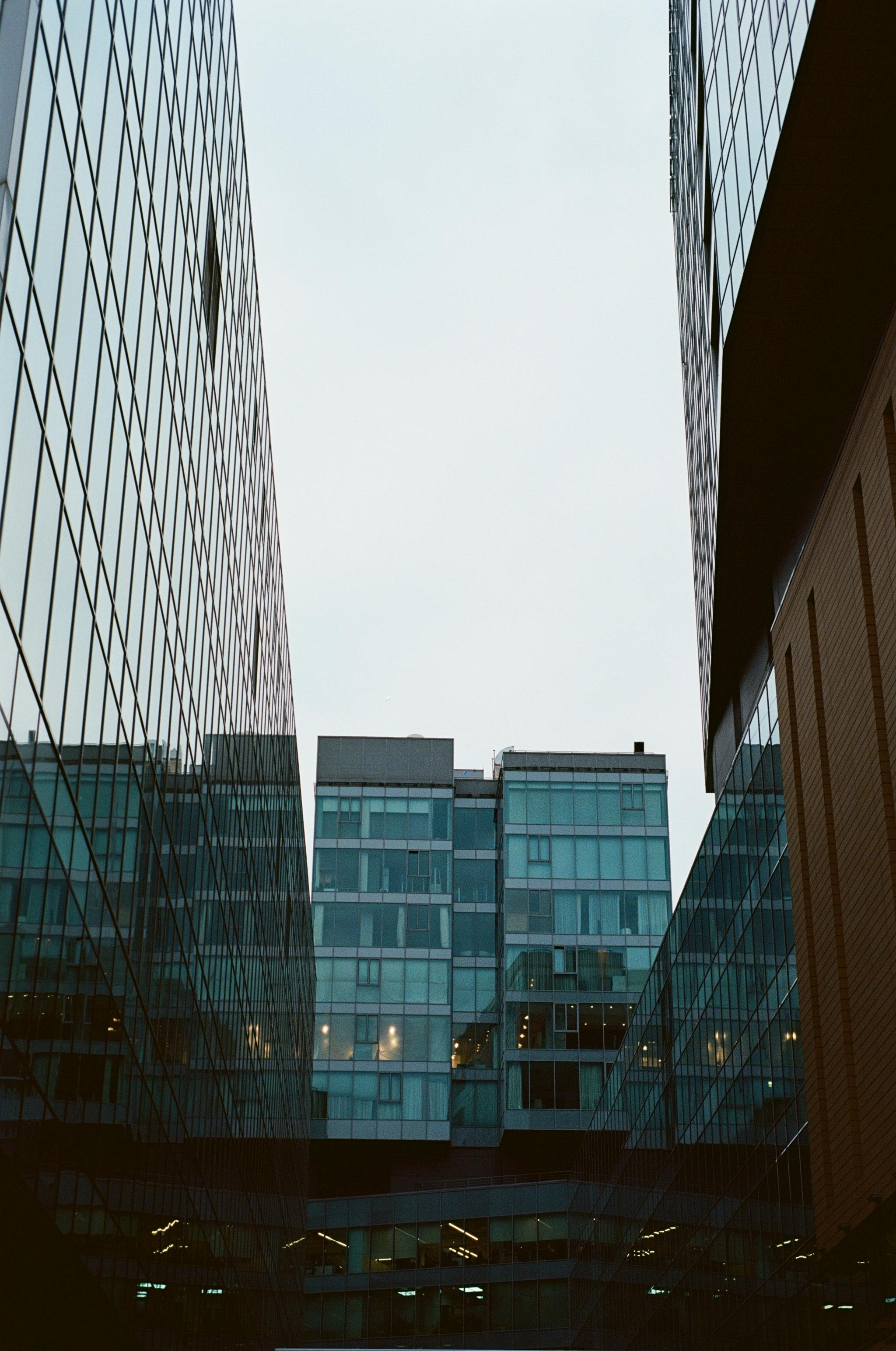 Tall glass buildings reflecting the cityscape create a dynamic urban scene in Moscow.