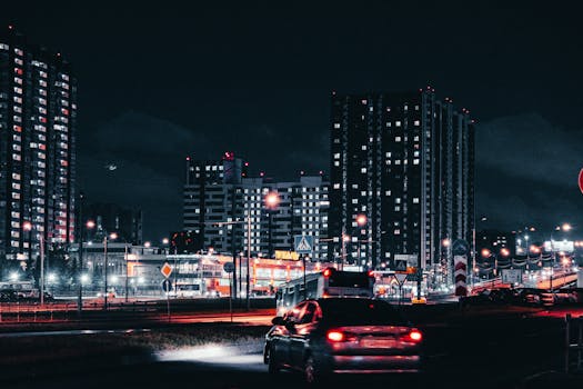 Captivating night view of Moscow cityscape with tall buildings, cars, and illuminated streets.