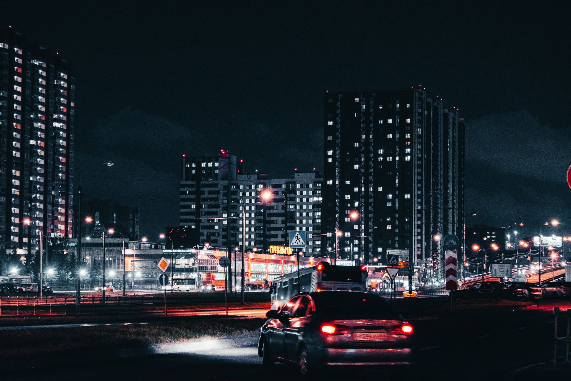 Captivating night view of Moscow cityscape with tall buildings, cars, and illuminated streets.
