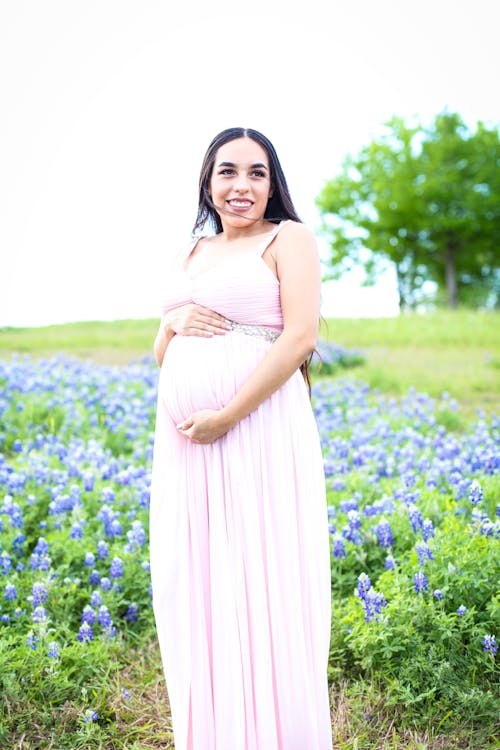 Pregnant Wearing Pink Dress Surrounded With Lavender