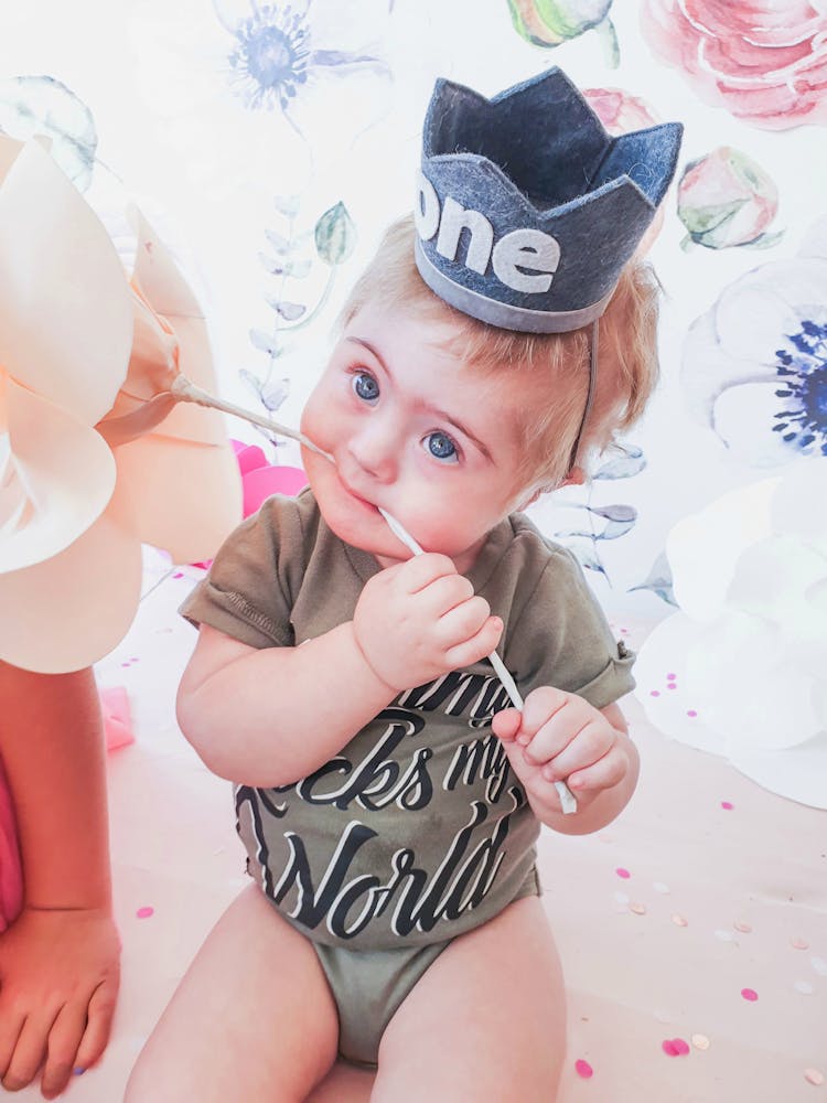 Blue Eyed Baby Biting A Flower Decoration