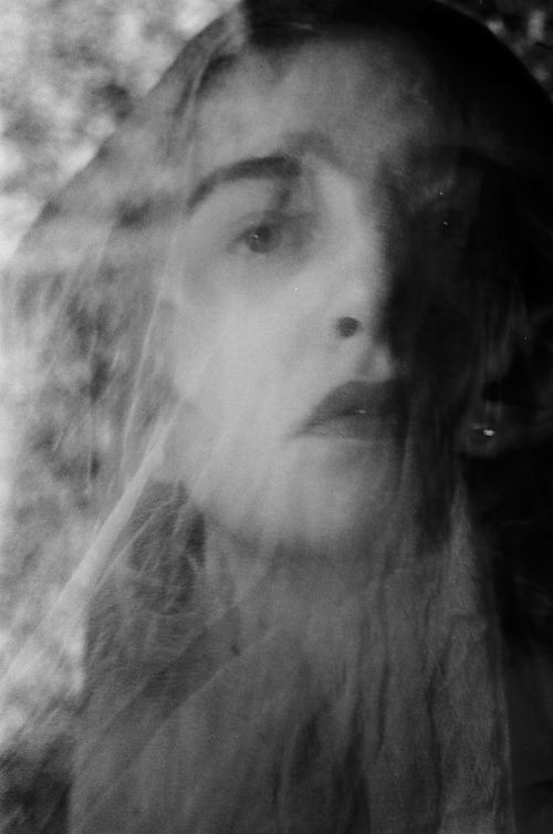 Free Haunting black and white portrait of a woman with an ethereal, ghostly veil effect. Stock Photo
