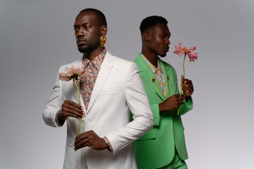 Two Men Holding Pink Flowers