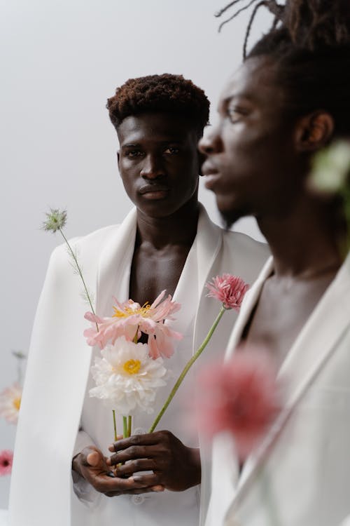 Free Two Men Holding Pink Flowers Stock Photo