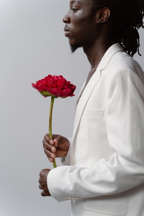 Side View of a Man Holding a Pink Carnation Flower 