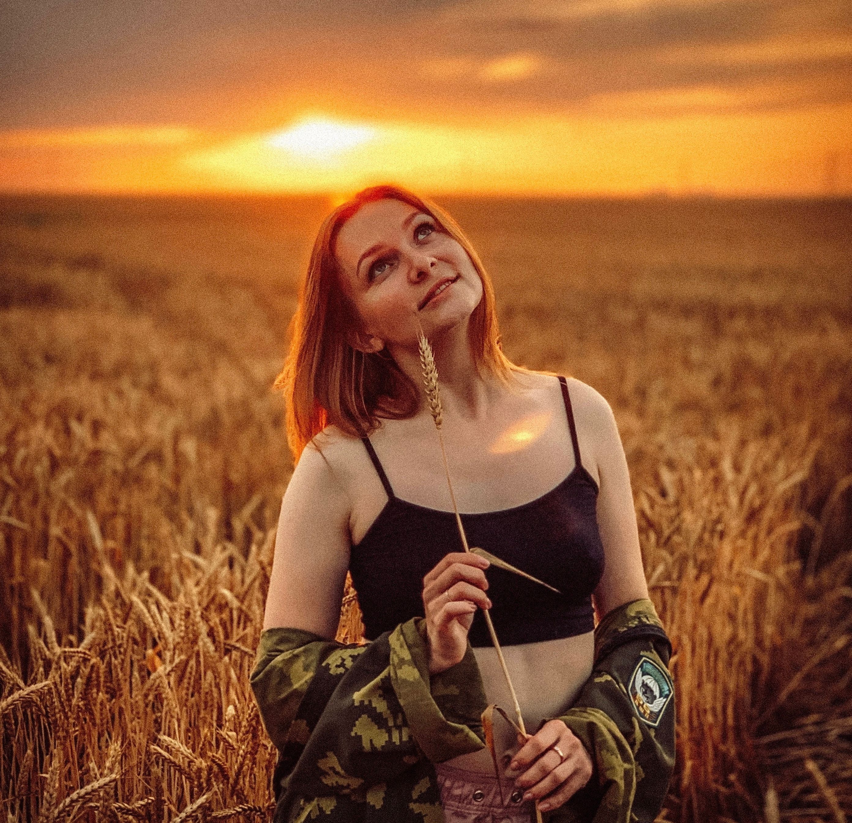 A Woman on a Wheat Field During Golden Hour · Free Stock Photo