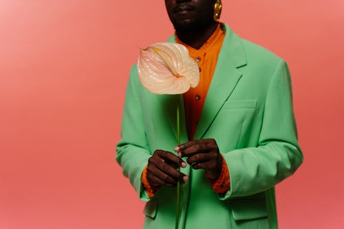 Free Man in Colorful Suit Holding a Flower Stock Photo