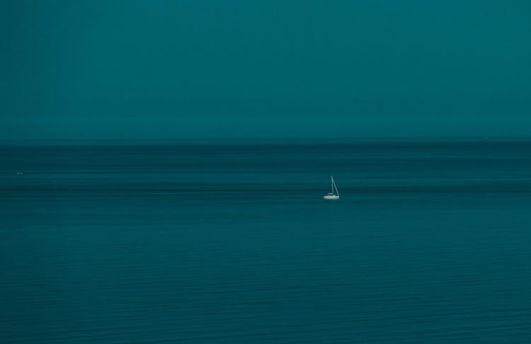 Small White Boat On Water
